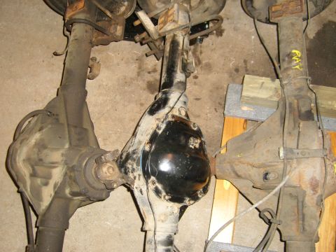 1994 Ford Bronco - Three vehicle rear axles are shown, with one a newly painted black differential cover.
