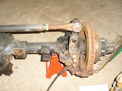 1994 Ford Bronco - Close-up of a vehicle's front axle assembly, including steering and braking components.