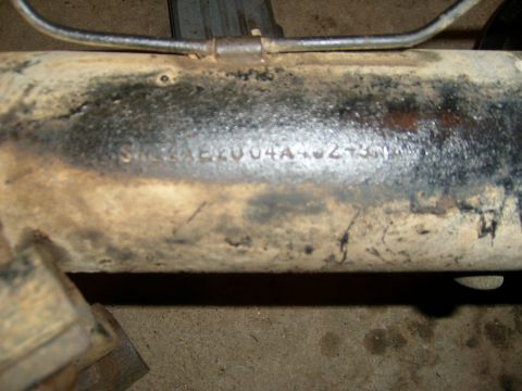 1994 Ford Bronco - Stamped numbers on a vehicle part, possibly an axle housing.