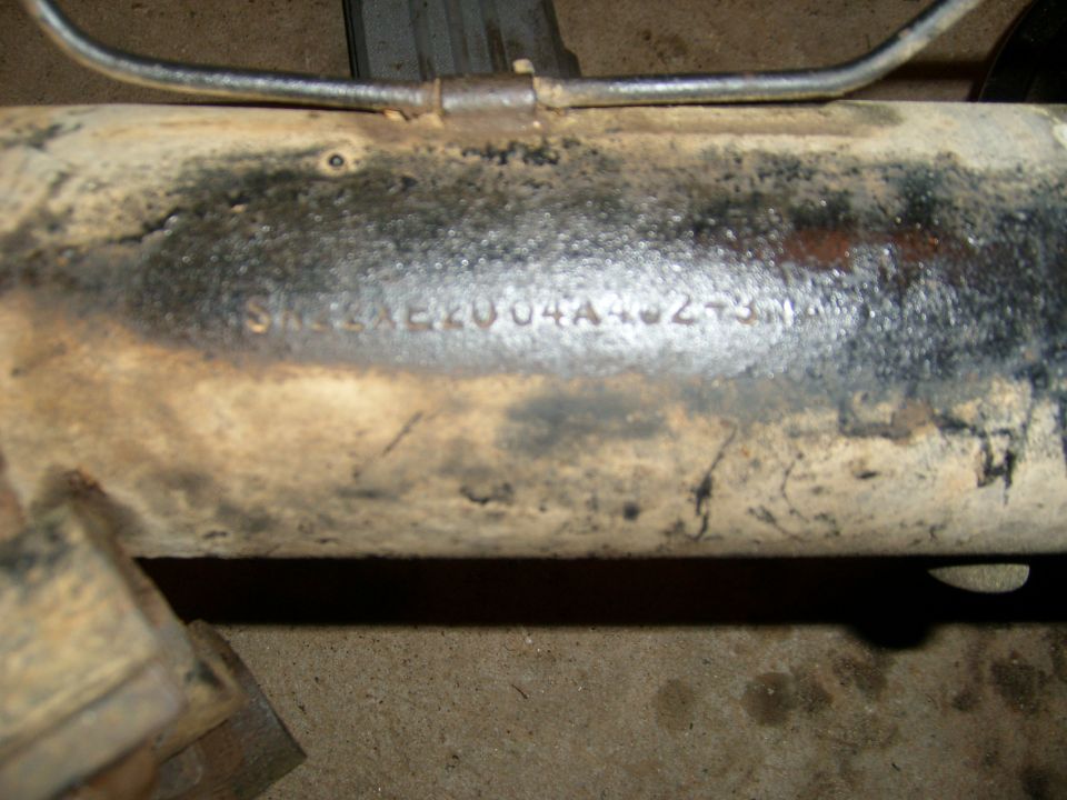 Close-up of a metal tube with stamped numbers: SM22AE2004A40273N