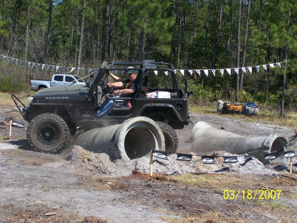 Black Jeep Wrangler Rubicon navigating concrete pipes, 2007 date stamp