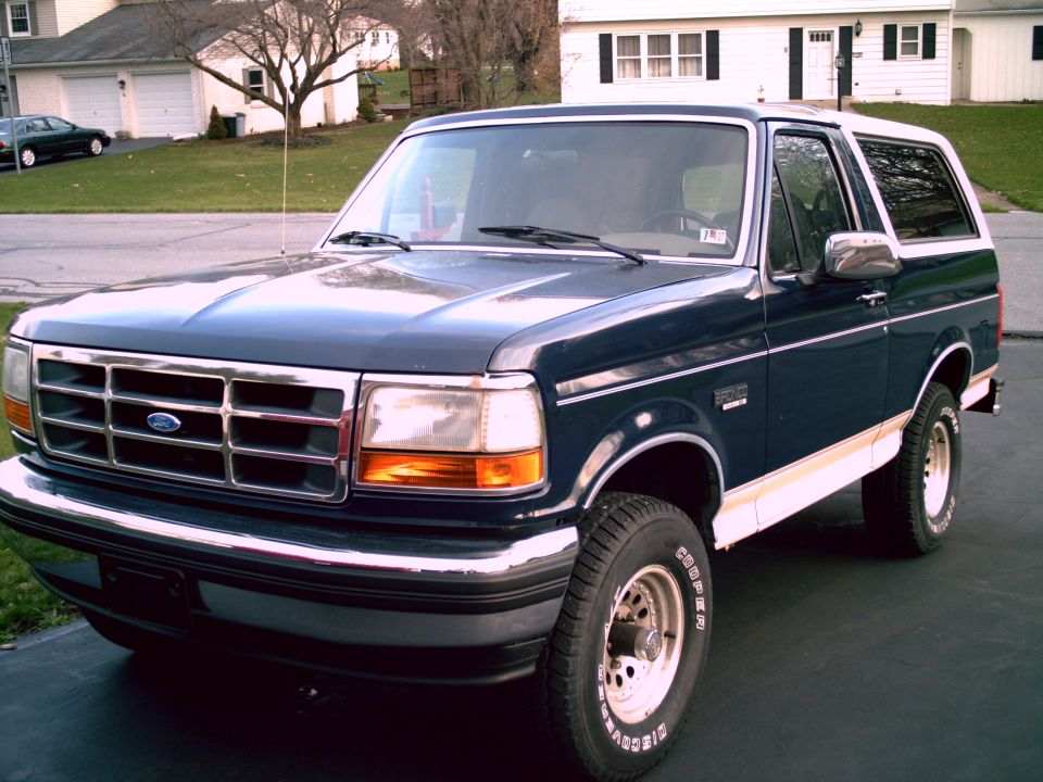 Dark blue 1993 Ford Bronco with white trim and a white roof