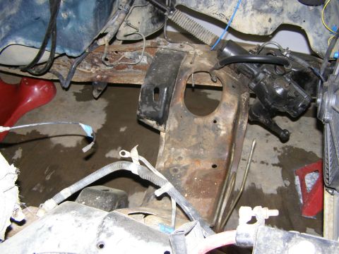 1993 Ford Bronco - Close-up view of the engine bay, showing rusty frame components and steering mechanism.
