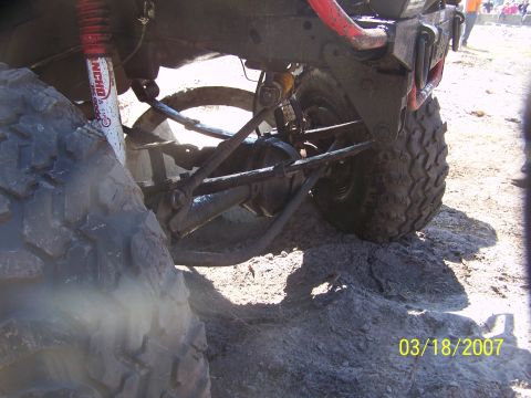 1989 Ford Bronco - Close-up of a muddy off-road vehicle's rear suspension and tire, with a date stamp of 03/18/2007.