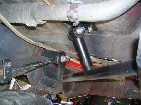 1985 Ford Bronco - Close-up of a vehicle's undercarriage, focusing on the rear suspension system and sway bar components.