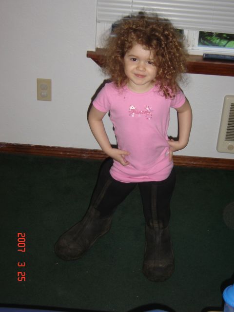 1993 Ford Bronco - A young child poses for a photo, wearing a pink t-shirt and tall black boots.