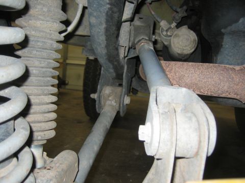 2001 Jeep Wrangler - Close-up view of the rear suspension system of a Jeep Wrangler, showing various mechanical components.