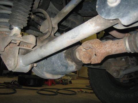 2001 Jeep Wrangler - Close-up view of the front axle and driveshaft components on a Jeep Wrangler.