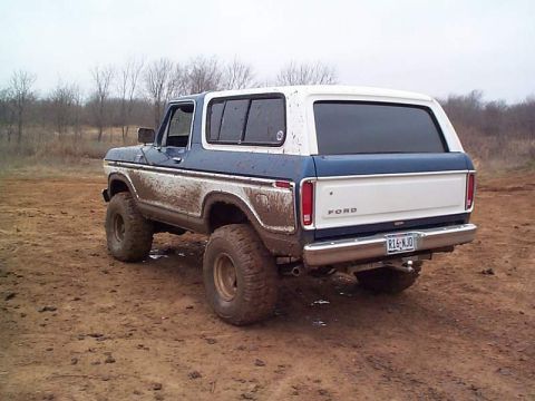 1978 Ford Bronco - Mud-covered 1978 Ford Bronco on a dirt track.