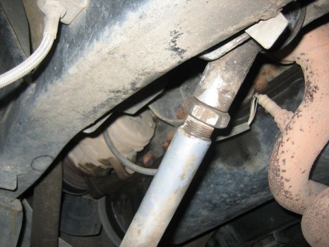 2001 Jeep Wrangler - Underside view of a vehicle's exhaust system, focusing on a pipe and sensor connection.