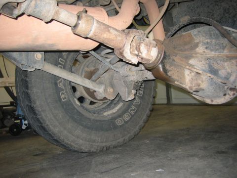 2001 Jeep Wrangler - Close-up view of a vehicle's rear axle and driveshaft, with a tire visible.