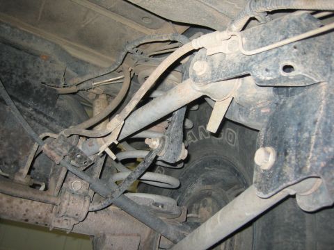 2001 Jeep Wrangler - Close-up of the rear suspension system, showing various mechanical parts and a tire.