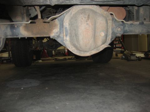 2001 Jeep Wrangler - Underside view of a vehicle's rear axle and suspension components, with tires visible.
