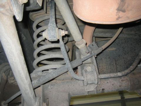 2001 Jeep Wrangler - Close-up view of the rear suspension system, showing the coil spring and associated mechanical components.