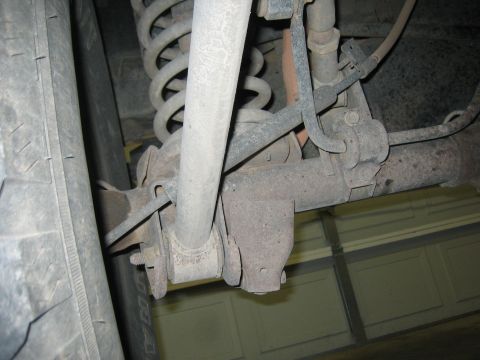 2001 Jeep Wrangler - Vehicle's rear suspension system detail, showing coil spring and shock absorber attachment points.