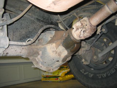 2001 Jeep Wrangler - Undercarriage view of a vehicle's driveshaft and differential assembly.