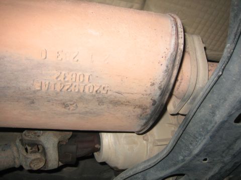2001 Jeep Wrangler - A close-up view of an exhaust system part with visible part numbers and markings.