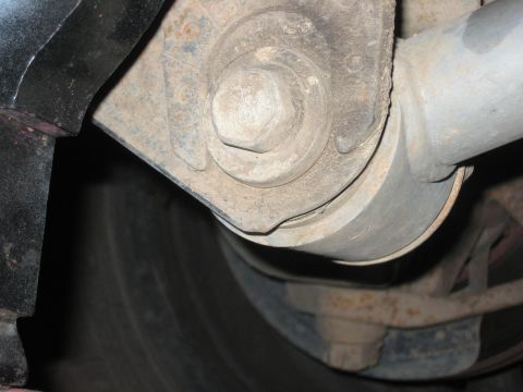 2001 Jeep Wrangler - A close-up view of a vehicle's suspension system, focusing on a large bolt and surrounding components.
