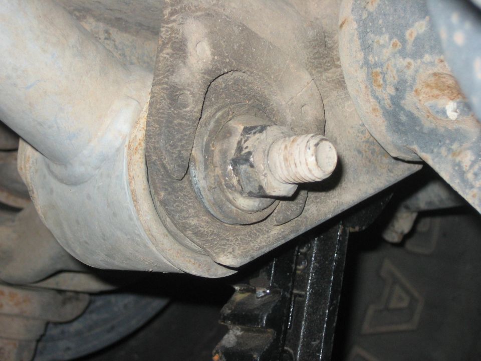 Close-up of a suspension bushing and bolt on a vehicle