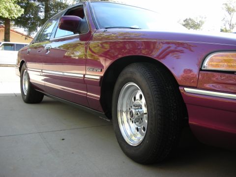1992 Ford Crown Victoria - Side view of a 1992 Ford Crown Victoria with chrome wheels.
