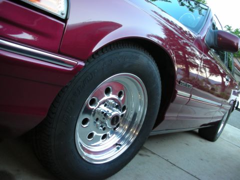 1992 Ford Crown Victoria - Close-up of a 1992 Ford Crown Victoria's front fender and wheel.