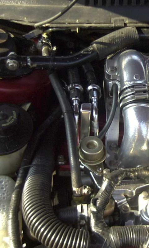 1997 Ford Taurus - Close-up view of various engine bay parts and hoses.