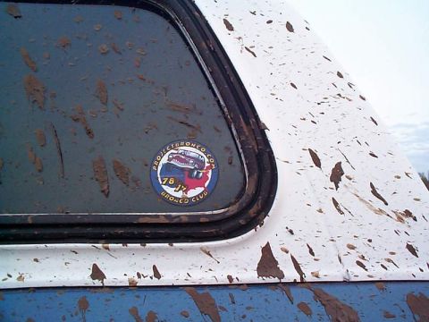 1978 Ford Bronco - Sticker on the window of a muddy vehicle indicates it's part of the '78 Bronco Club.