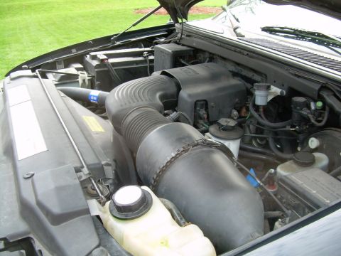 1997 Ford F-150 - Close-up view of the engine bay of a 1997 Ford F-150, showing the air intake system and battery.