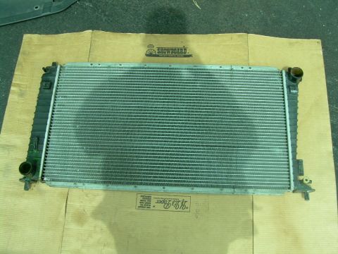 1997 Ford F-150 - A radiator part is shown laid out on a piece of cardboard.
