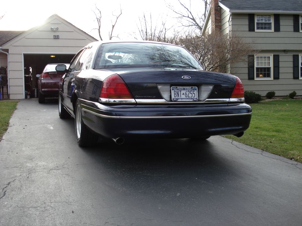 Rear view of a dark blue 2000 Ford Crown Victoria with a license plate reading BNT-6255
