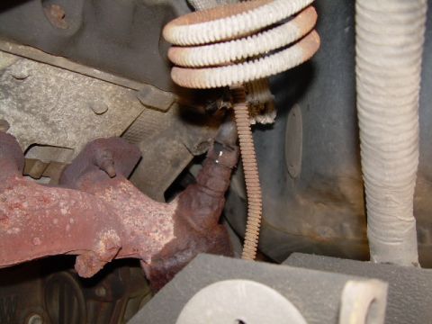 1997 Ford F-150 - Close-up view of a rusty exhaust manifold and EGR air tube assembly.