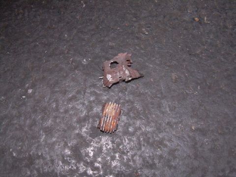 1997 Ford F-150 - Rusted metal components are shown on a concrete floor.