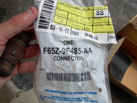 1997 Ford F-150 - A Ford EGR air tube connector part is shown in its original packaging with the part number F65Z-9F485-AA.