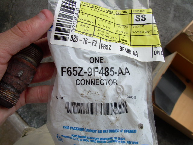 Ford EGR air tube connector part in plastic packaging with part number F65Z-9F485-AA