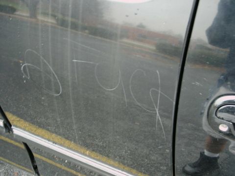 1997 Ford F-150 - Scratches on a vehicle door spell out the word 'truck'.