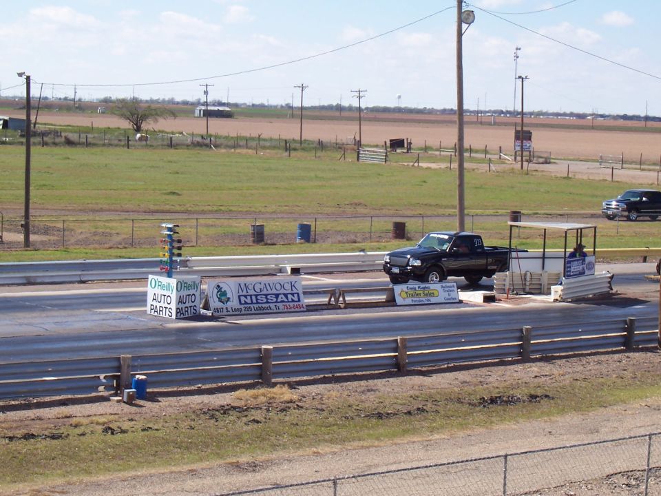 Black Ford Ranger pickup truck at drag strip starting line
