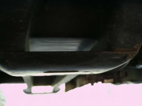 1997 Ford F-150 - The underside of a vehicle's frame is visible, showing some rust and structural components.
