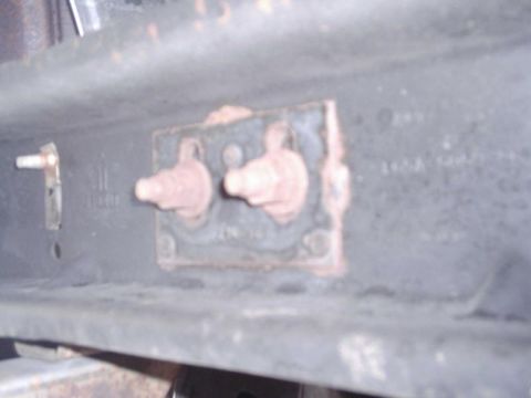 1997 Ford F-150 - Close-up view of a vehicle crossmember a mounting plate with two bolts.