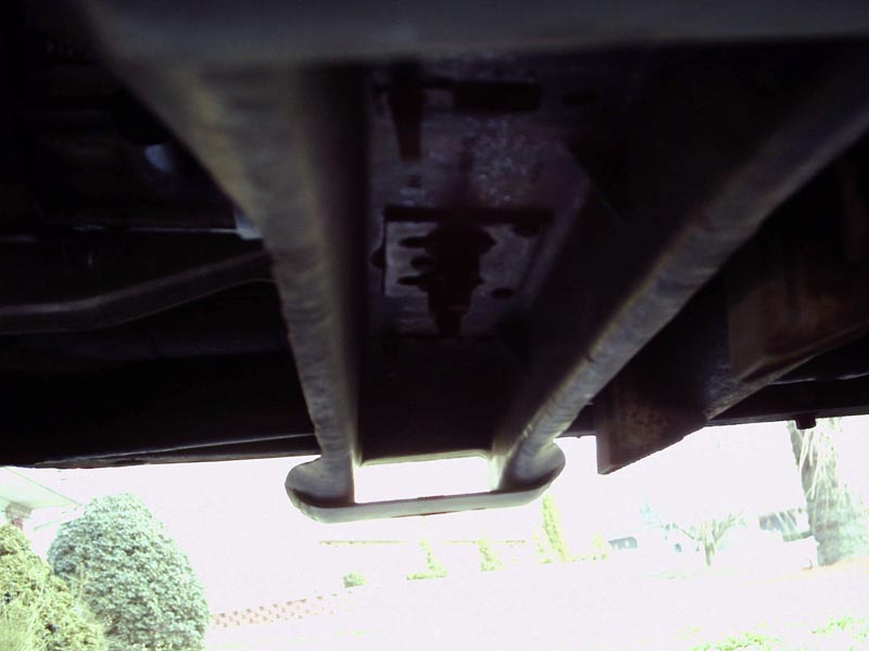 Close-up of a vehicle's underbody crossmember and mounting hardware