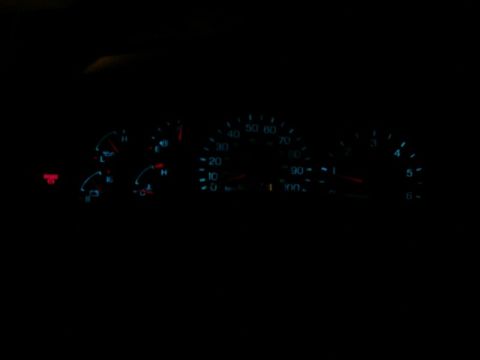 1997 Ford F-150 - The illuminated dashboard gauges of a 1997 Ford F-150 are visible in the dark interior.