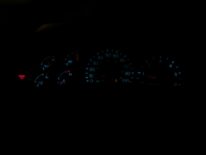 Dashboard gauges of a 1997 Ford F-150 at night, showing speedometer, tachometer, fuel, and oil levels