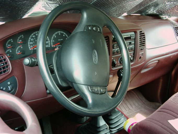 1997 Ford F-150 interior showing dashboard, steering wheel, and floor shifter