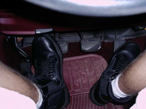 1997 Ford F-150 - Close-up view of the brake, clutch, and accelerator pedals inside a vehicle.