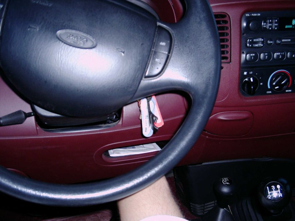 Ford truck steering wheel airbag, dash radio and HVAC controls with red interior