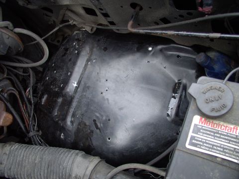 1986 Ford Bronco - I re-drilled and relocated the plastic wiring harness loops further down the wheelhouse, away from the center, where the toolbox sits. Noti…