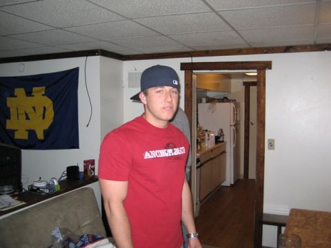 1996 Ford Bronco - A man stands in a room with a Notre Dame flag and a kitchen visible in the background.