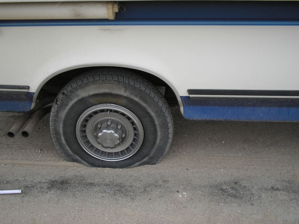 Flat tire on 1989 Ford F-250 side view