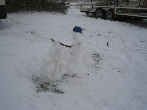 1989 Ford F-250 - Snowman built in a snowy yard, with a trailer visible in the background.