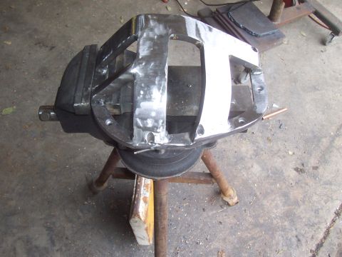 1994 Ford F-150 - A metal differential housing is being worked on, clamped in a vise on a stand.