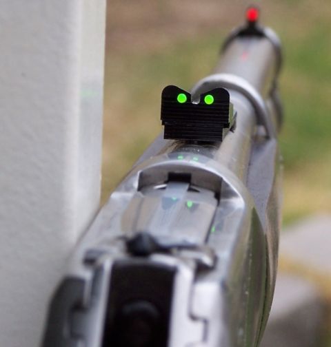 1990 Ford Bronco - Close-up of pistol sights, showing green front dots and a red rear sight.